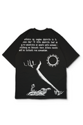 An Oversized t-shirt with a white graphic print on the back, featuring a quote by Berserk Manga and surreal illustrations of a skeletal hand, a sun, and the ritual. Design by Bakaka
