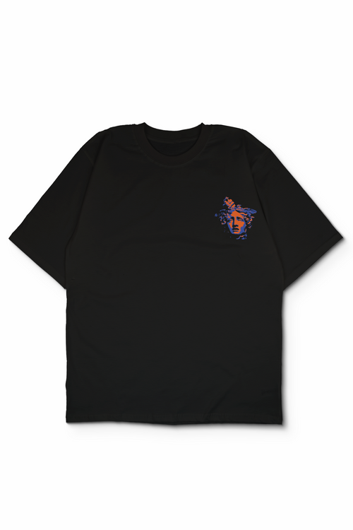An Oversized t-shirt with a small colorful graphic on the left chest, displayed flat against a white background showing beheaded head of medusa held by perseus. Design by bakaka.