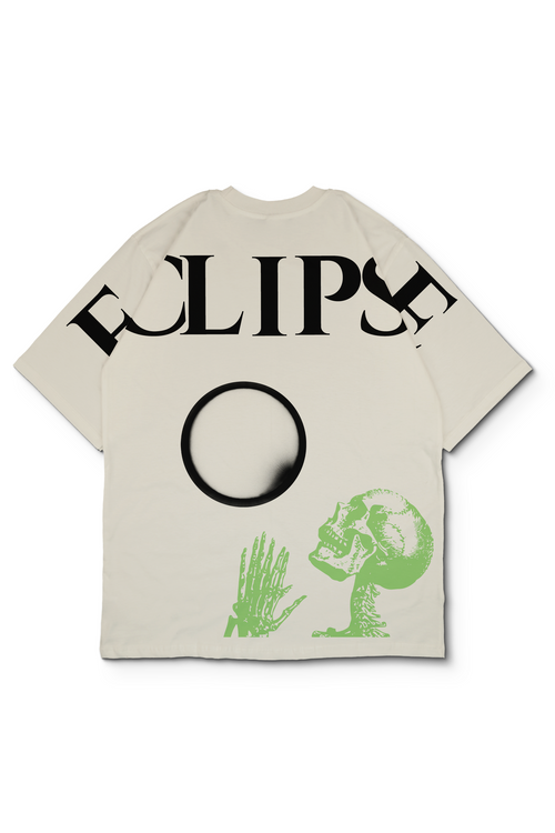 An oversized off white-colored t-shirt featuring a black graphic print of the word 'ECLIPSE' across the shoulder, moon in the center, and a green skull and hand graphic on the lower front. Design by bakaka.